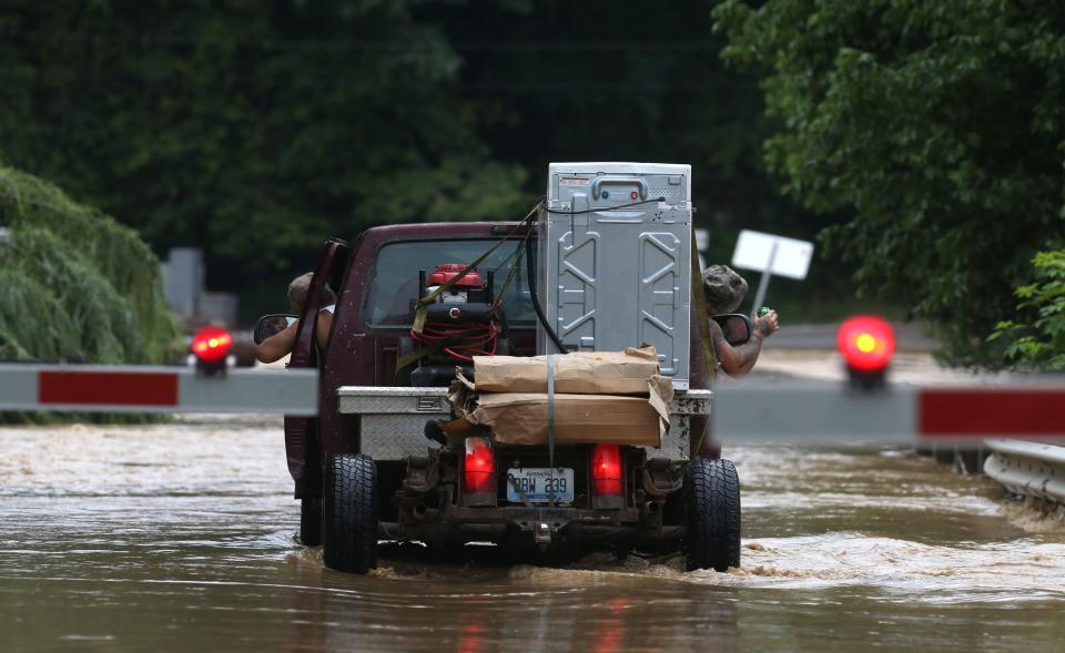 Two guys in a truck kept their eyes out as they crossed a bridge that was covered with water in Garrett.July 28, 2022