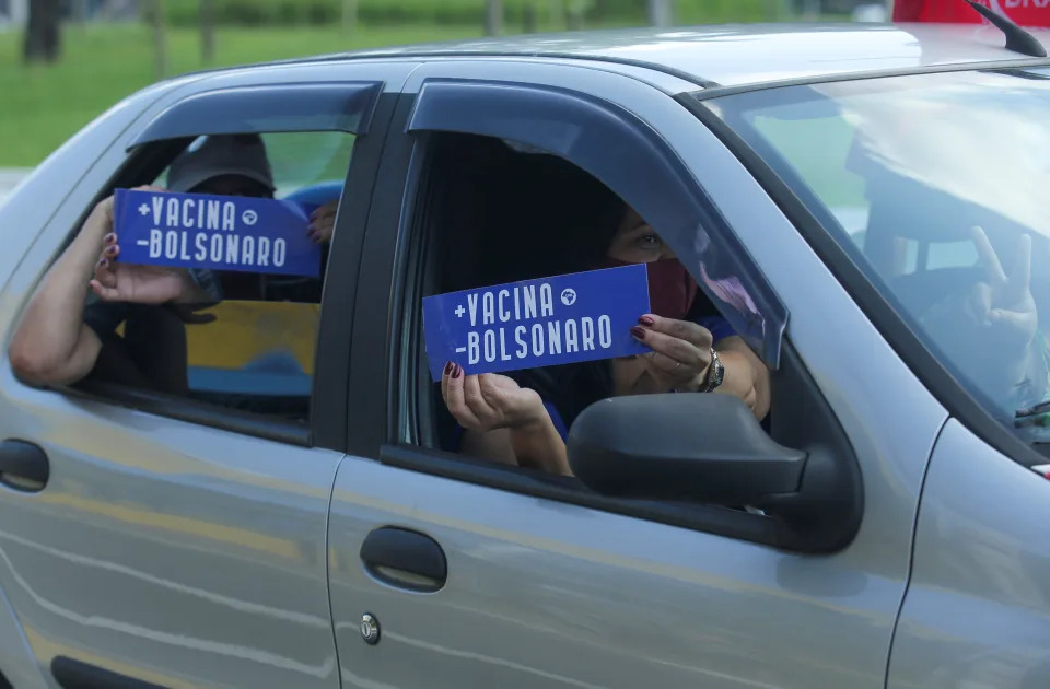 People hold signs reading 