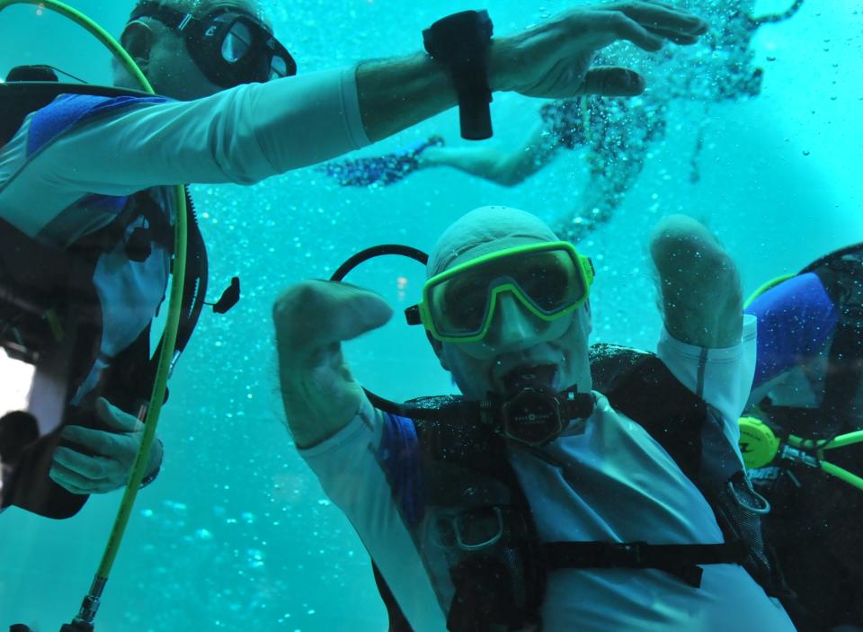 French Philippe Croizon, 44, celebrates underwater on January 10, 2013 after becoming the first quadruple amputee to dive at a depth of 33 meters in the deepest swiming pool in the world in Brussels. He used flippers attached to prosthetic limbs to dive with a group of 15 Belgian divers to the bottom of the pool to set a new world record for an amputee. Croizon had all four limbs amputated in 1994 after being struck by an electric shock of more than 20,000 volts as he tried to remove a TV antenna from a roof. He has swum across the English Channel and all five intercontinental channels. AFP PHOTO GEORGES GOBETGEORGES GOBET/AFP/Getty Images