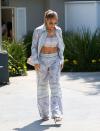 <p>Stepping out in the Los Angeles sunshine, Jennifer Lopez looked straight out on the early 2000s with her 'Love Don't Cost A Thing'-era gold jewellery and belly-baring outfit.</p><p>The mother-of-two wore an Emilio Pucci three-piece outfit consisting of wide-leg trousers, an open shirt and crop top, plus some vertiginous silver heels. </p><p><a class="link rapid-noclick-resp" href="https://www.farfetch.com/uk/shopping/women/emilio-pucci-conchiglie-print-palazzo-trousers-item-16017050.aspx?storeid=10949" rel="nofollow noopener" target="_blank" data-ylk="slk:SHOP JENNIFER LOPEZ'S TROUSERS NOW">SHOP JENNIFER LOPEZ'S TROUSERS NOW</a></p>