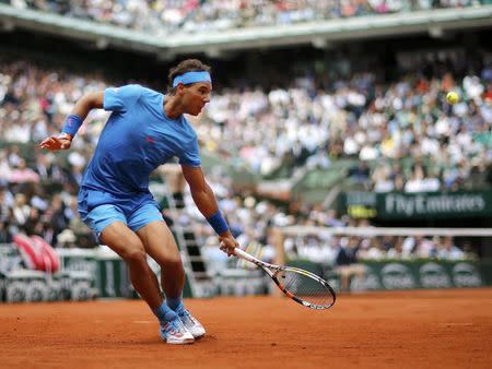 Rafael Nadal of Spain plays a shot to Quentin Halys of France during their men's singles match at the French Open tennis tournament at the Roland Garros stadium in Paris, France, May 26, 2015. REUTERS/Jean-Paul Pelissier