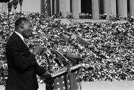 <p>The Rev. Martin Luther King addresses a crowd estimated at 70,000 at a civil rights rally in Chicago’s Soldier Field, June 21, 1964. (AP Photo/Charles E. Knoblock) </p>