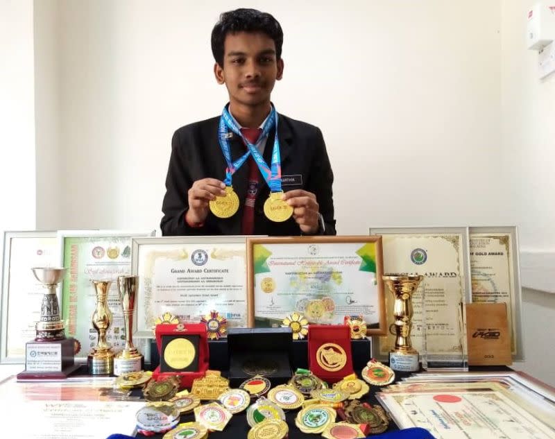 Karthikgesan showing his gold medals that he won for creating eco-friendly pots in the recent virtual global competition. — Picture courtesy of Karthikgesan Santharasekaran