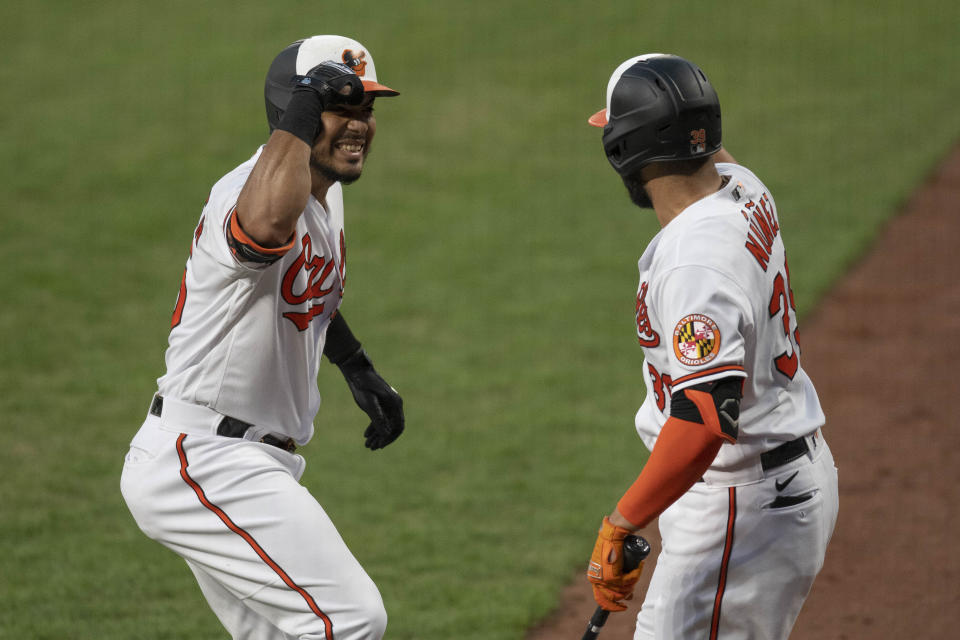 Baltimore Orioles' Anthony Santander during reacts with Renato Nunez after hitting a two run home run during the first inning of a baseball game against the Toronto Blue Jays, Tuesday, Aug. 18, 2020, in Baltimore. (AP Photo/Tommy Gilligan)