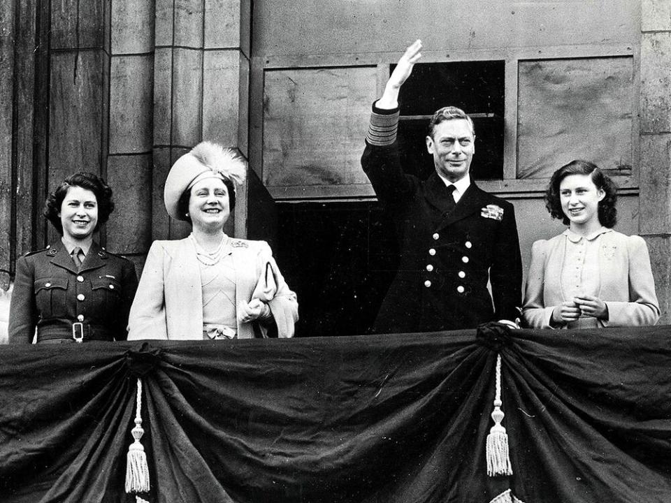 King George VI stands with Queen Elizabeth (later the Queen Mother) and their two children Princess Elizabeth (later Queen Elizabeth II) and Princess Margaret in 1945 | Popperfoto/Getty