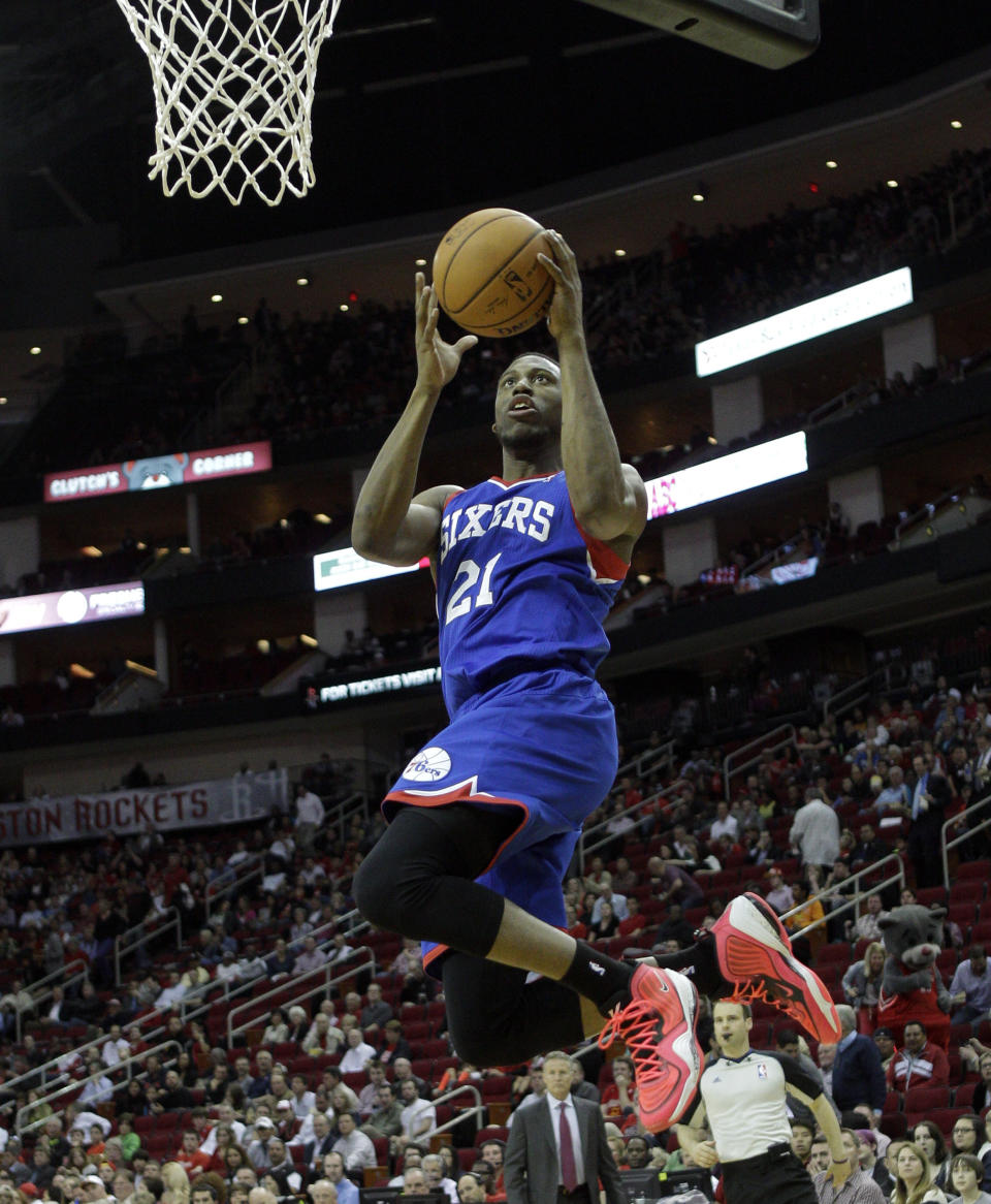 Philadelphia 76ers' Thaddeus Young (21) drives to the basket for a layup against the Houston Rockets during the first half of an NBA basketball game on Thursday, March 27, 2014, in Houston. (AP Photo/Bob Levey)