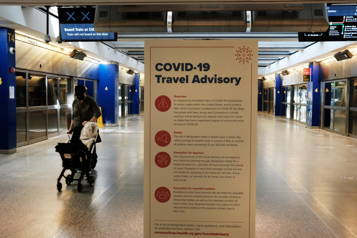 NEW YORK, NEW YORK - JANUARY 25: Covid-19 information is displayed at an international terminal at John F. Kennedy Airport (JFK) on January 25, 2021 in New York City. In an effort to further control Covid-19 transmission, President Joe Biden plans to sign restrictions on travel to the United States. The ban will prohibit travelers from the United Kingdom, Ireland and 26 countries in Europe that allow travel across open borders, called the Schengen Area. The new measures will also block entry to travelers from Brazil and South Africa. (Photo by Spencer Platt/Getty Images)