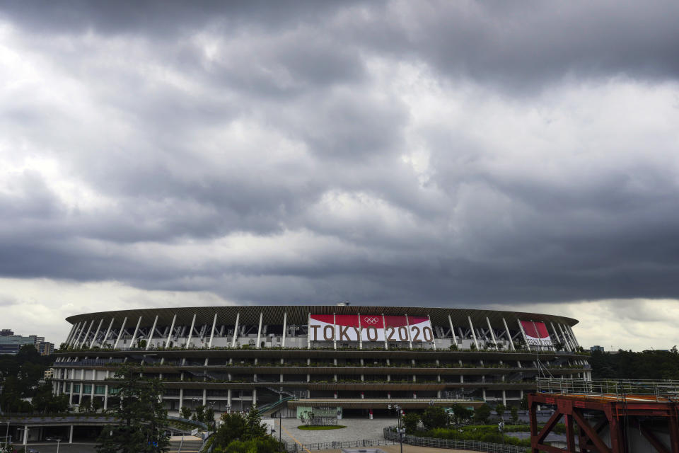 Rain clouds move in over National Stadium Wednesday, June 23, 2021, in Tokyo, one month before the July 23 opening of Tokyo Olympics. The Tokyo Olympics, already delayed by the pandemic, are not looking like much fun: Not for athletes. Not for fans. And not for the Japanese public. They are caught between concerns about the coronavirus at a time when few are vaccinated on one side and politicians who hope to save face by holding the games and the International Olympic Committee with billions of dollars on the line on the other. (AP Photo/Kiichiro Sato)