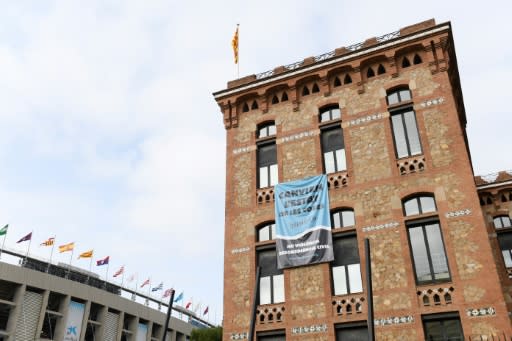 A banner reading "Change the state of things" by the Catalan separatist movement Democratic Tsunami hangs from a building next to Barcelona's Camp Nou stadium prior to Wednesday's hotly-anticipated Clasico