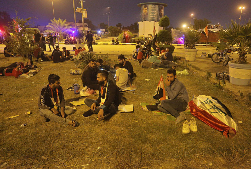 Anti-government protesters rest during a sit-in near the closed Najaf provincial council, Iraq, early Monday, Oct. 28, 2019. Protests have resumed in Iraq after a wave of anti-government protests earlier this month were violently put down. (AP Photo/Anmar Khalil)