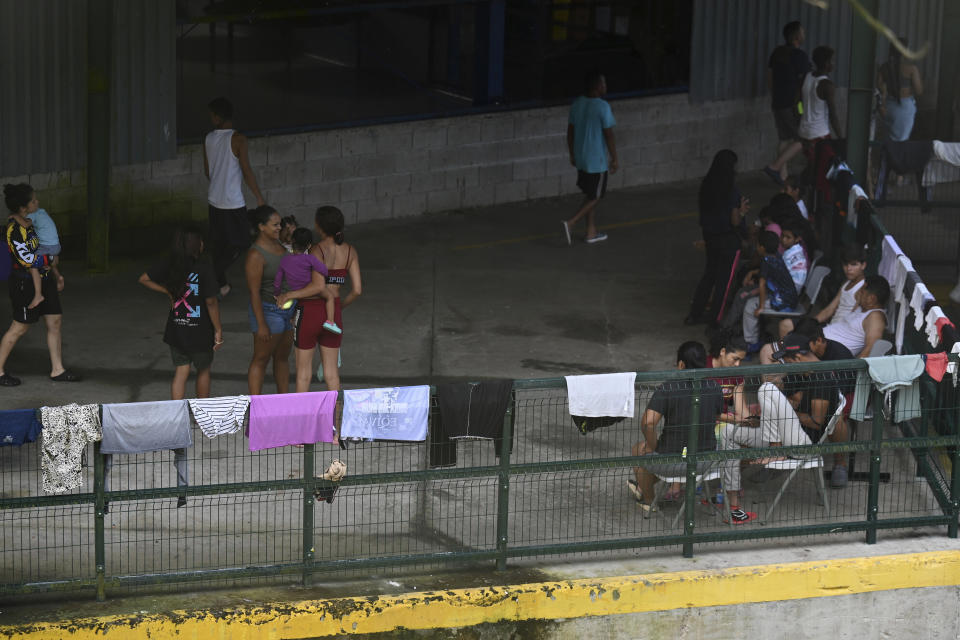 Migrants from Venezuela wait for transportation to continue on their way north to Nicaragua and hopefully to the Mexico-United States border, in Paso Canoas, Costa Rica, Monday, Oct. 16, 2023. Panama and Costa Rica launched a plan to quickly bus thousands of migrants through Panama to the Costa Rican border, as the countries continue to grapple with the increasing number of migrants. (AP Photo/Carlos Gonzalez)