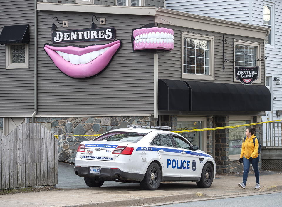 FILE - The Atlantic Denture Clinic, owned by Gabriel Wortman, is guarded by police in Dartmouth, Nova Scotia, on Monday, April 20, 2020. A public inquiry has found widespread failures in how Canada’s federal police force responded to the country’s worst mass shooting, Thursday, March 30, 2023. It recommends that the government rethink the Royal Canadian Mounted Police’s central role in Canadian policing. (Andrew Vaughan/The Canadian Press via AP, File)