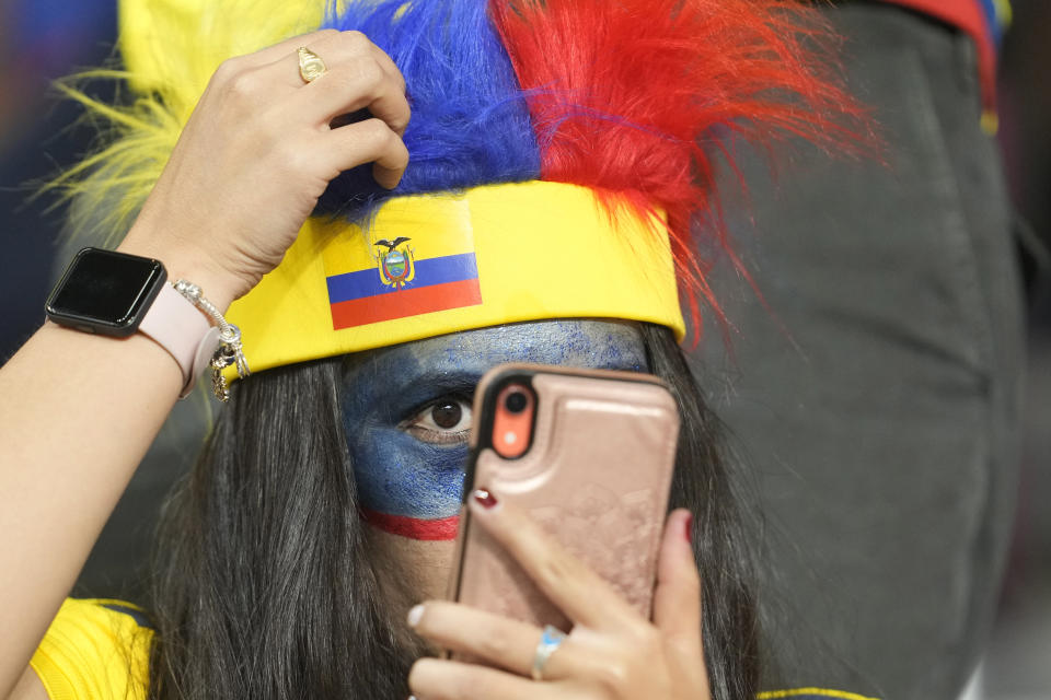 A Ecuador's fan adjusts her hat before the World Cup group A soccer match between Netherlands and Ecuador at the Khalifa International Stadium in Doha, Qatar, Friday, Nov. 25, 2022. (AP Photo/Darko Vojinovic)