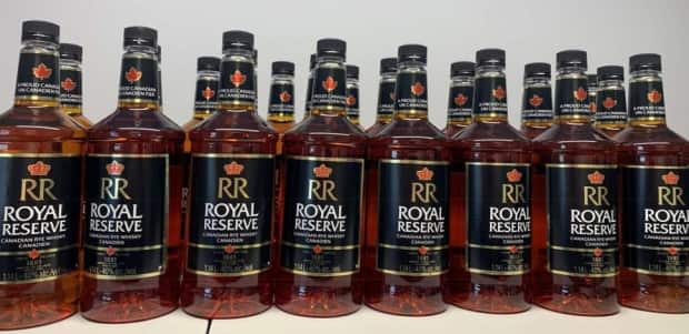 Rankin Inlet RCMP charged a 44-year-old man in January 2021 after seizing 24 bottles of alcohol as part of an ongoing investigation into allegation of bootlegging in the community . (RCMP - image credit)