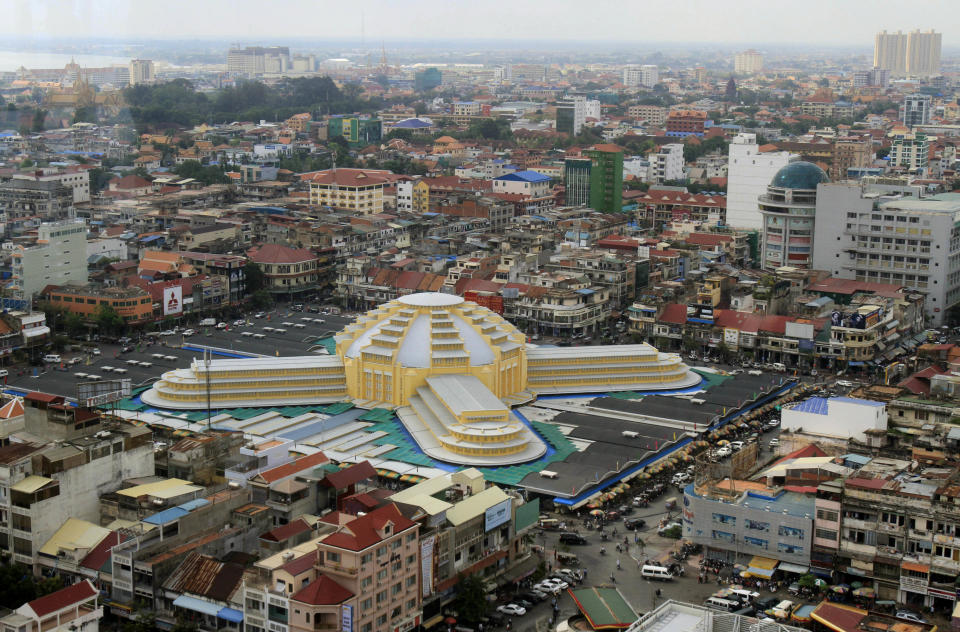 This photo taken, April 18, 2012, shows an overview of the Central Market (Phsar Thum They) in Phnom Penh, Cambodia. Beneath a lemon-yellow art deco dome, the Central Market offers miles of no-strings-attached window-shopping. But if you can't stand the thought of leaving empty-handed, pick up flip-flops, jewelry, delicacies like juicy mangosteen fruit or fried insects, or khama scarves in bright, gingham-like patterns. On Friday, Saturday and Sunday nights, the nearby Night Market (Phsar Reatrey) becomes to go-to spot for displaying handicrafts produced by local artisans.(AP Photo/Heng Sinith)
