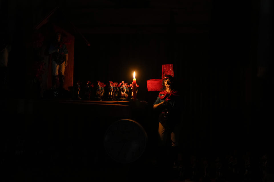 Figures of Argentina's folk Saint "Gauchito" Gil are illuminated by a candle at his sanctuary in Mercedes, Corrientes, Argentina, Sunday, Jan. 7, 2024. Every Jan. 8, devotees from across the country visit his sanctuary to ask for miracles or give him thanks.(AP Photo/Natacha Pisarenko)