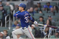 Texas Rangers' Evan Carter hits a solo home run off Atlanta Braves pitcher Darius Vines in the fourth inning of a baseball game Sunday, April 21, 2024, in Atlanta. (AP Photo/John Bazemore)