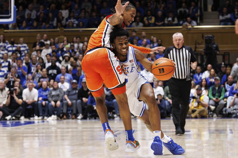 Duke's Jeremy Roach, right, is fouled by Syracuse's Judah Mintz, left, during the second half of an NCAA college basketball game in Durham, N.C., Tuesday, Jan. 2, 2024. (AP Photo/Ben McKeown)