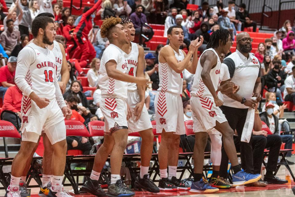 The Oak Hills' bench celebrates after a three pointer that helped seal a 69-57 victory over Hesperia on Friday, Jan. 21, 2022.