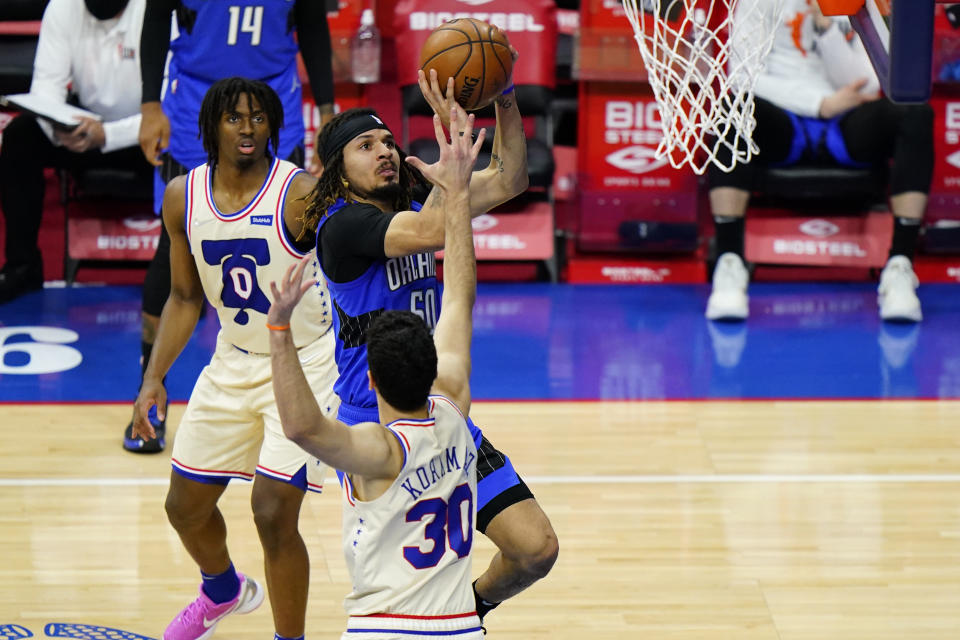 Orlando Magic's Cole Anthony (50) goes up for a shot against Philadelphia 76ers' Furkan Korkmaz (30) during the second half of an NBA basketball game, Sunday, May 16, 2021, in Philadelphia. (AP Photo/Matt Slocum)