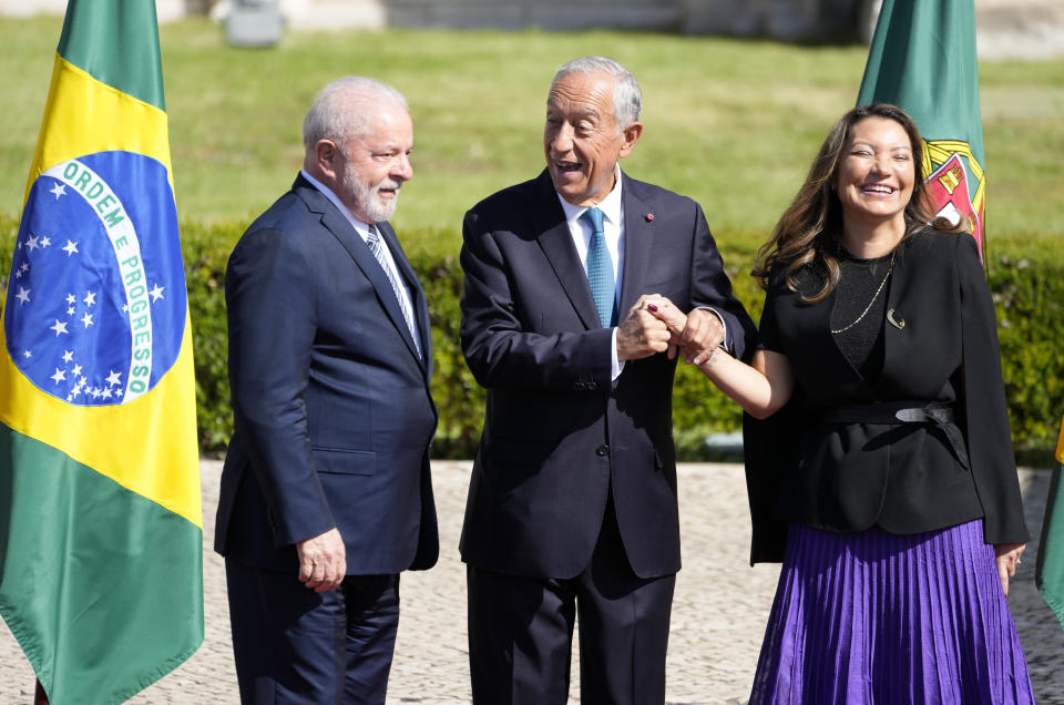 Portuguese President Marcelo Rebelo de Sousa shakes hand with Brazilian first lady Rosangela da Silva, next to Brazilian president Luis Inacio Lula da Silva, outside the 16th century Jeronimos monastery in Lisbon, Saturday, April 22, 2023. Lula da Silva is in Lisbon for a four day state visit to Portugal. (AP Photo/Armando Franca)