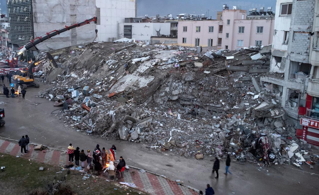 An aerial photo taken by a drone shows emergency personnel during a search and rescue operation at the site of a collapsed building after an earthquake in Iskenderun, district of Hatay (EPA)