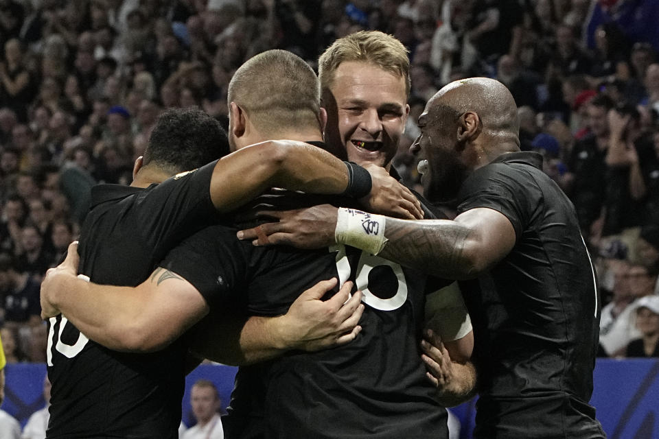 New Zealand's Dane Coles, second left, is congratulated by teammates after scoring a try during the Rugby World Cup Pool A match between New Zealand and Italy at the OL Stadium in Lyon, France, Friday, Sept. 29, 2023. (AP Photo/Laurent Cipriani)