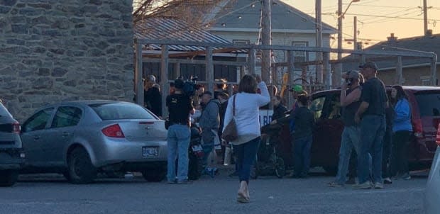 People gather outside the South Branch Bistro on April 8, 2021. The AGCO says they found people contravening Ontario's pandemic rules when they attended the anti-lockdown rally and again when they returned the next day.