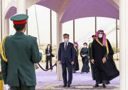 In this photo released by the Saudi Royal Palace, Saudi Crown Prince Mohammed bin Salman, right, and South Korean President Moon Jae-in, stand for an honor guard at Riyadh International Airport, Saudi Arabia, Tuesday, Jan. 18, 2022. It is the latest visit by a head of state to Saudi Arabia as a growing number of world leaders resume bilateral meetings and trips abroad following COVID-19 vaccine rollouts in many parts of the world. (Bandar Aljaloud/Saudi Royal Palace via AP)