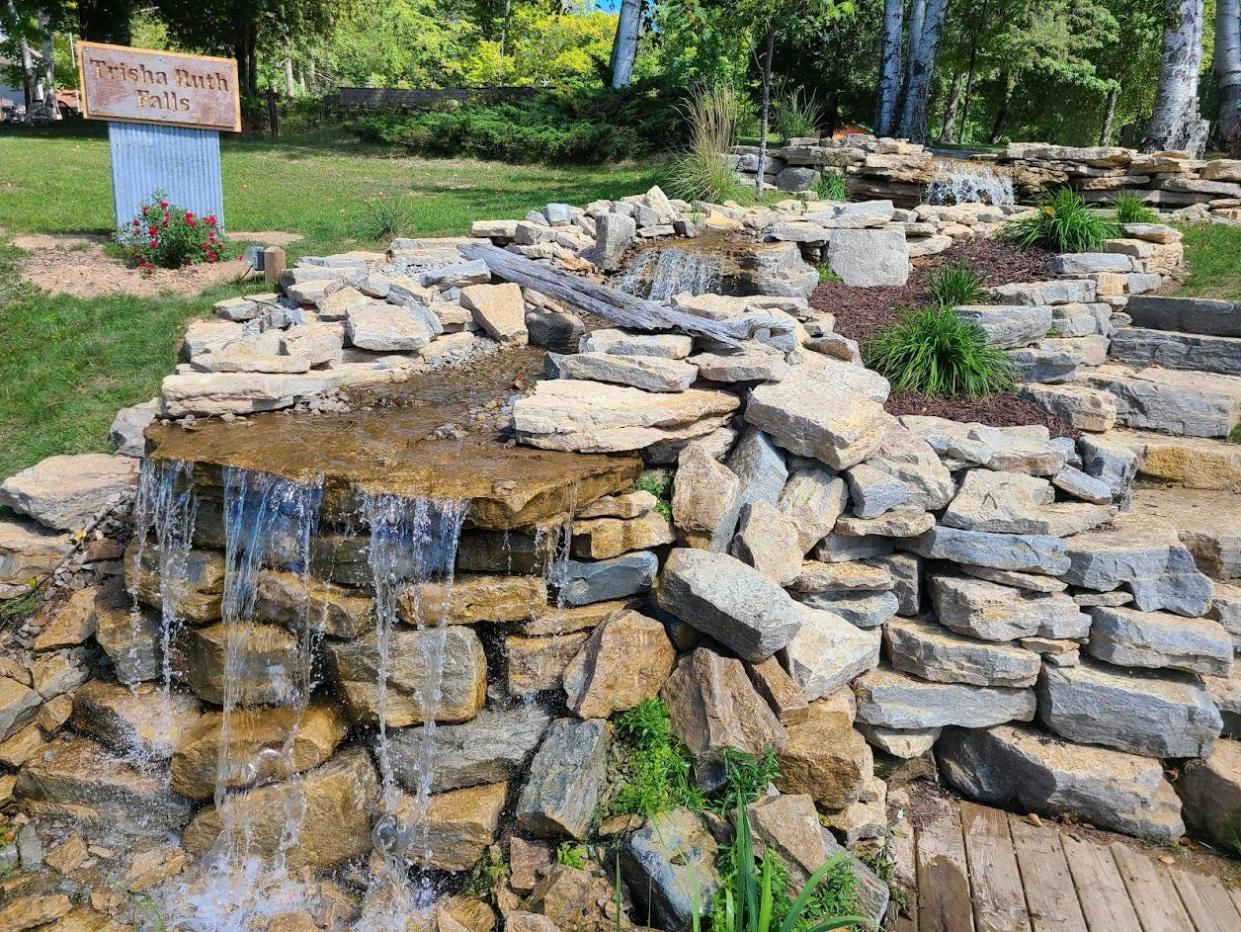 A personal memorial waterfall, dubbed Trisha Ruth Falls, created at a cottage owned by David and Lori Magnin in Townsend along Reservoir Pond, has been ordered to be removed. The waterfall honors their daughter and sister, who died in 2021.