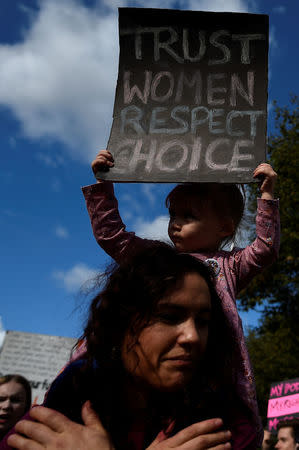 Demonstrators hold posters as they march for more liberal Irish abortion laws, in Dublin, Ireland September 30, 2017. REUTERS/Clodagh Kilcoyne