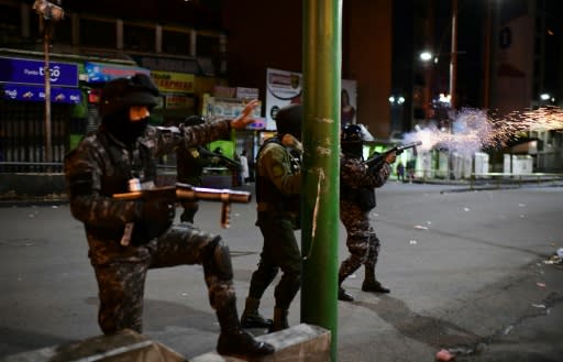 Security forces confront supporters of resigned president Evo Moralez in La Paz after Jeanine Anez, a deputy speaker of the senate, proclaimed herself Bolivia's interim president during a session of Congress that failed to reach a quorum