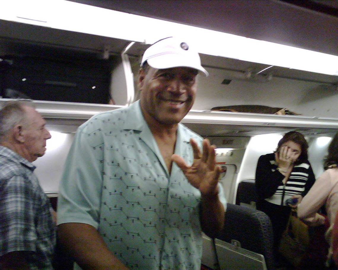 O.J. Simpson waves to the photographer, Miami Herald reporter Evan Benn. Both where on a plane flying from Las Vegas to Florida. Benn was covering O.J. Simpson’s preliminary hearing. Evan Benn/Miami Herald File