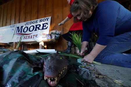 Workers set up an artificial "swamp" outside a venue where Republican Senate candidate Roy Moore will hold a rally in Midland City, Alabama, U.S., December 11, 2017. REUTERS/Carlo Allegri