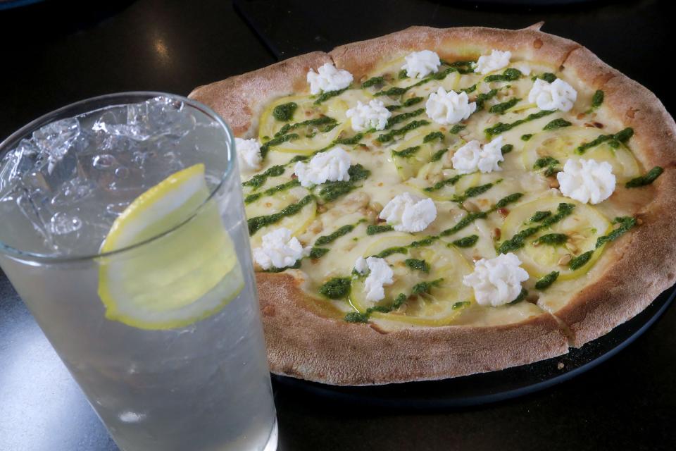 A Pinoli pizza (pine nuts, Fior di Latte, Ricotta, preserved lemon, basil pesto and Evoo) paired with fresh squeezed lemonade at Isola, a new Italian restaurant in Beach Haven.