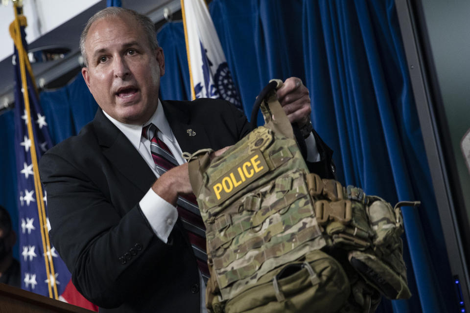 Mark Morgan, the acting Customs and Border Protection commissioner, holds up a protective vest worn by CBP agents in Portland during protests. (Samuel Corum/Getty Images)
