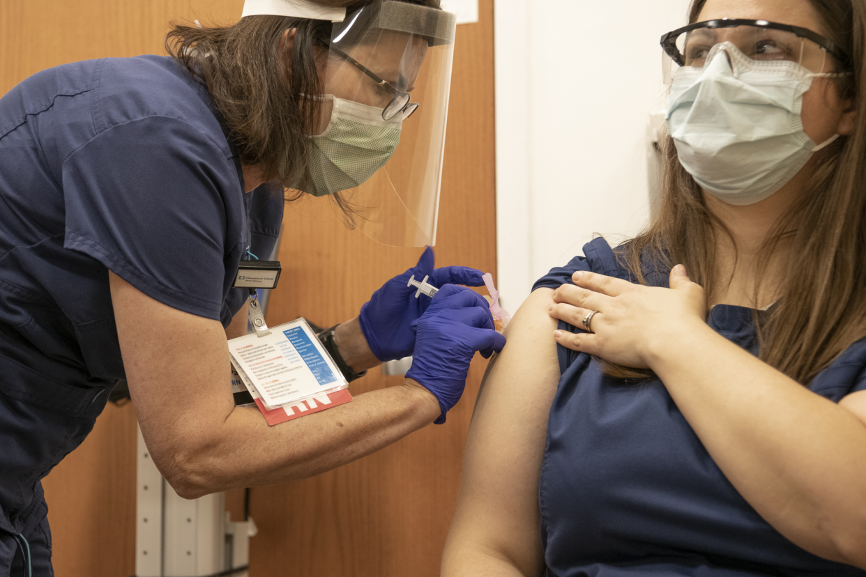 Melissa Salva, an assistant nurse manager in the cardiac and neuro ICU at Cleveland Clinic Akron General, receives a COVID-19 vaccine on Dec. 24, 2020.