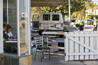 <p>A Los Angeles police investigator interviews a witness, at left, after a van plowed into a group of people on a Los Angeles sidewalk on Sunday, July 30, 2017. A witness to the crash told The Associated Press the van jumped a curb and careened into a group of people eating outside The Fish Spot restaurant in the city’s Mid-Wilshire neighborhood. The cause of the crash is under investigation. (AP Photo/Damian Dovarganes) </p>