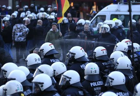 Police use pepper spray against supporters of anti-immigration right-wing movement PEGIDA (Patriotic Europeans Against the Islamisation of the West) during a demonstration march, in reaction to mass assaults on women on New Year's Eve, in Cologne, Germany, January 9, 2016. REUTERS/Ina Fassbender