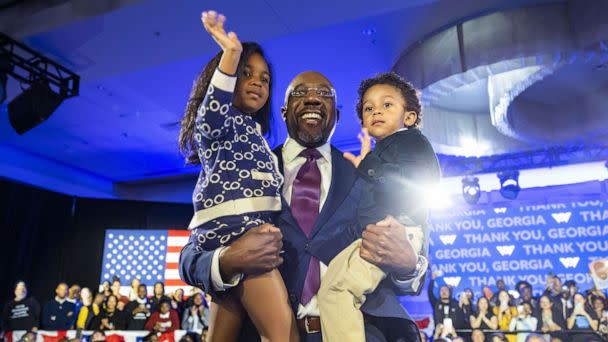 PHOTO: Senator Raphael Warnock holds his two children Chloe and Caleb after he was reelected to the Senate in Atlanta, Dec. 6 2022. (Jim Lo Scalzo/EPA-EFE via Shutterstock)