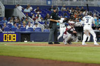 The pitch clock runs as Miami Marlins' Luis Arraez (3) bats during a baseball game against the Arizona Diamondbacks, Sunday, April 16, 2023, in Miami. (AP Photo/Lynne Sladky)