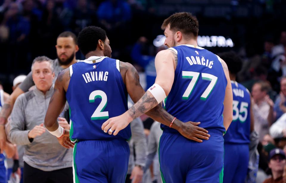 Kyrie Irving #2 and Luka Doncic #77 of the Dallas Mavericks celebrate against the Philadelphia 76ers at American Airlines Center on March 2, 2023 in Dallas, Texas. The Mavericks won 133-126.