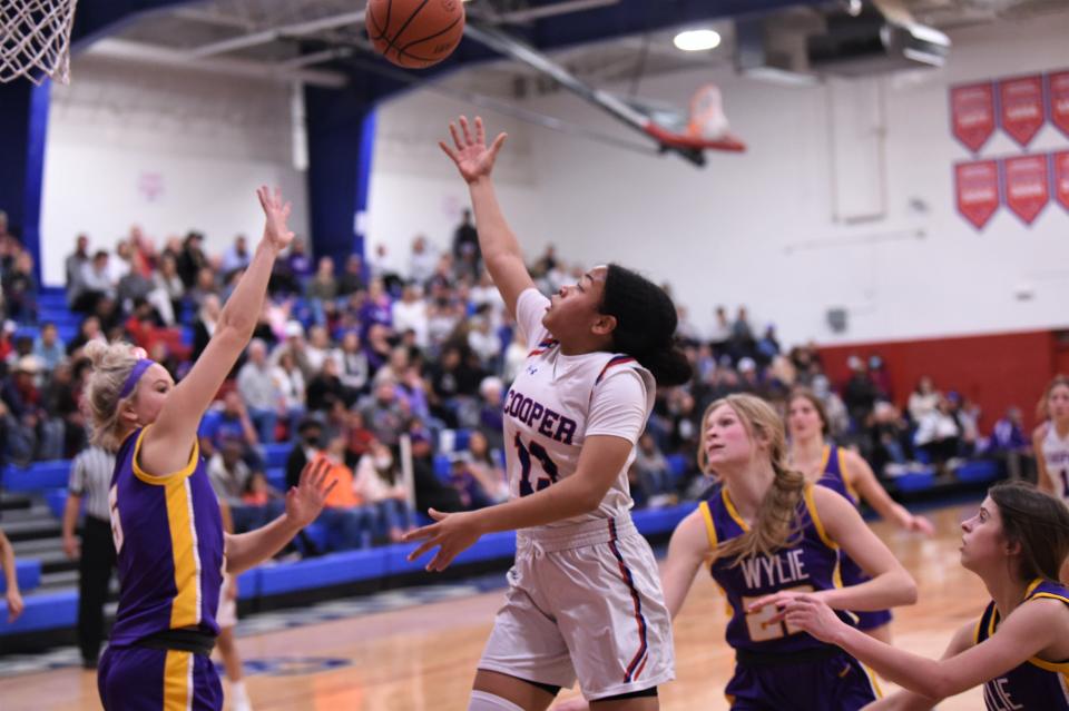 Cooper's Kyla Speights (13) floats a shot to the basket during Friday's Southtown game against Wylie. Speights scored 11 points in the 52-44 loss.