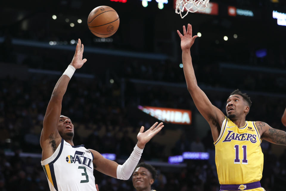 Utah Jazz guard Trent Forrest (3) shoots against Los Angeles Lakers guard Malik Monk (11) during the first half of an NBA basketball game in Los Angeles, Monday, Jan. 17, 2022. (AP Photo/Ringo H.W. Chiu)