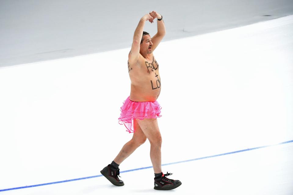 <p>A shirtless man clad in a tutu dances on the rink following the men’s 1,000m speed skating event medal ceremony during the Pyeongchang 2018 Winter Olympic Games at the Gangneung Oval in Gangneung on February 23, 2018. / AFP PHOTO / Roberto SCHMIDT </p>