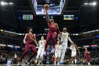 Cleveland Cavaliers guard Donovan Mitchell (45) shoots in front of Indiana Pacers forward Oshae Brissett (12) during the second half of an NBA basketball game in Indianapolis, Sunday, Feb. 5, 2023. (AP Photo/AJ Mast)