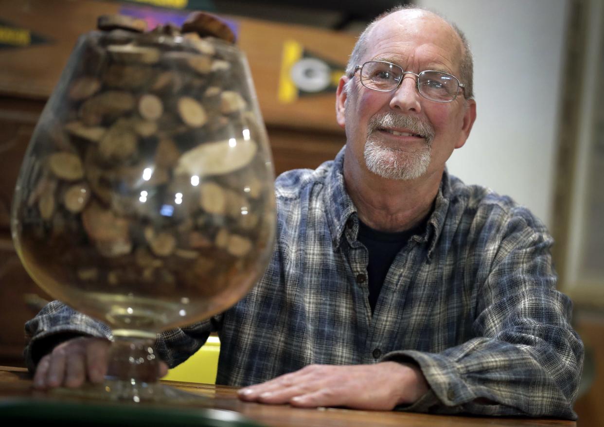 Tim Arnoldussen displays his collection of tree knots in a large brandy snifter at his home in the the town of Neenah.