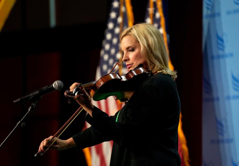 Iowa Rep. Ashley Hinson plays the violin at the Iowa Faith & Freedom Coalition's fall banquet, Saturday, Sept. 16, 2023, in Des Moines, Iowa. (AP Photo/Bryon Houlgrave)