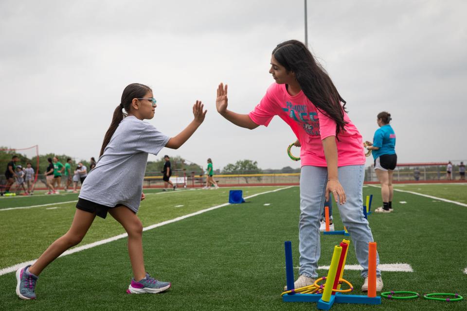 Premont junior Angelica Muniz high-fives Falfurrias student Dalaylah Duarte during a Special Olympics event on Wednesday, May 1, 2024, in Premont, Texas. Muniz is part of the Texas Association of Future Educators program.