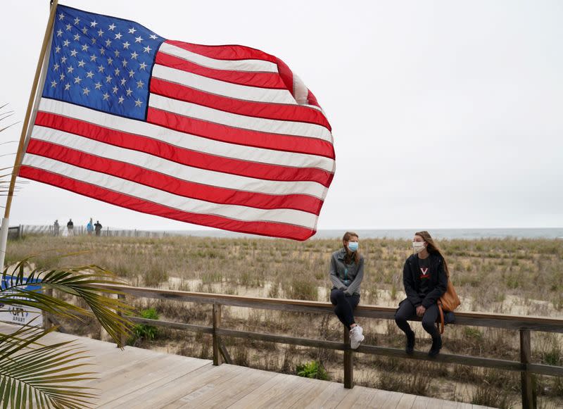 Women talk on the boardwalk at Bethany Beach in Delaware